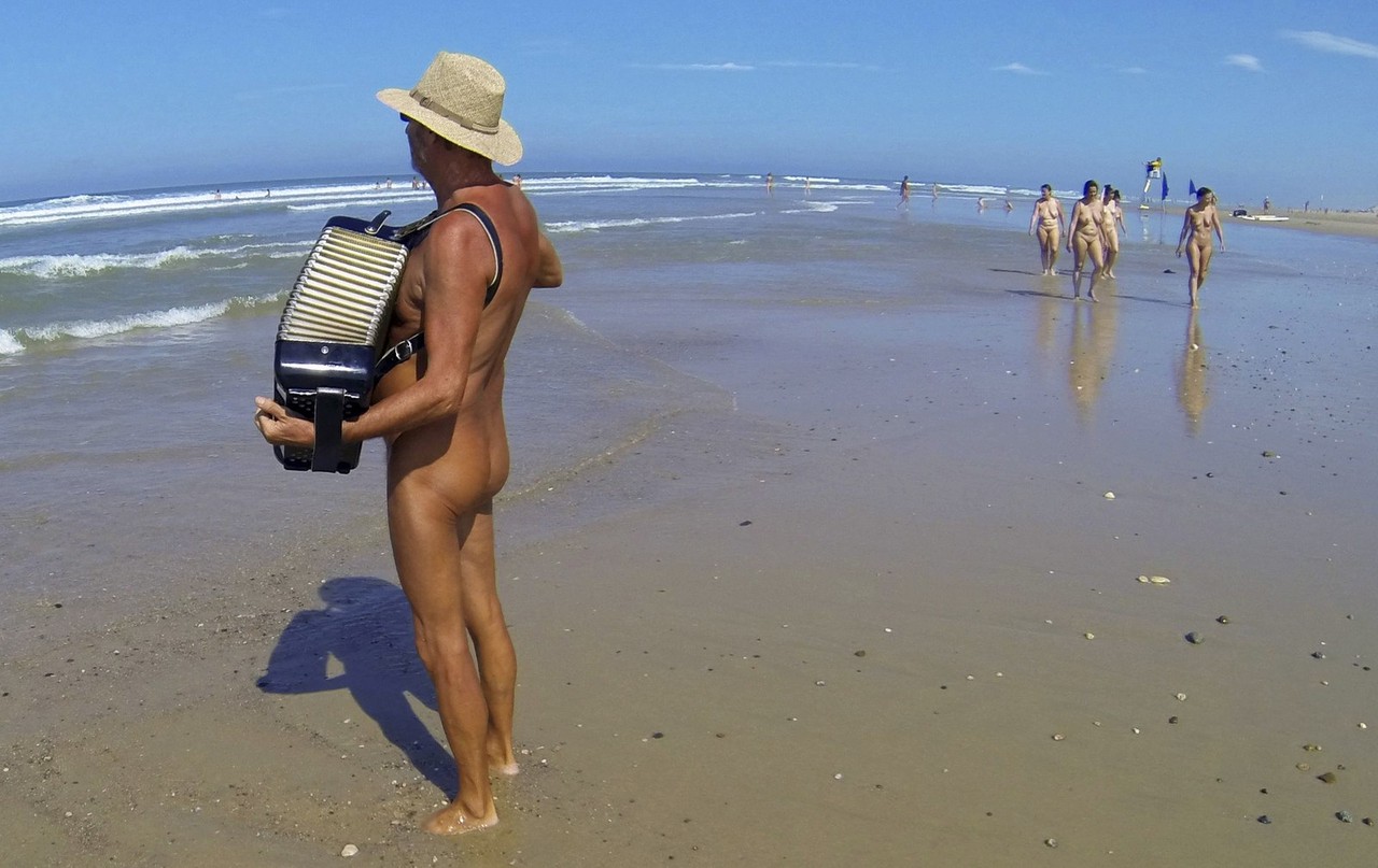 plays the accordion on the beach at the Centre Helio-Marin naturist campsit...